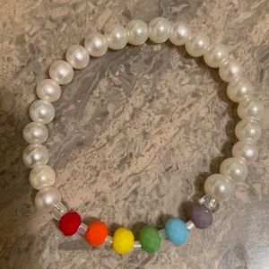 5 3/4” - 6”wrist. 6mm Rainbow crystal w/white pearl glass bead stretch bracelet.